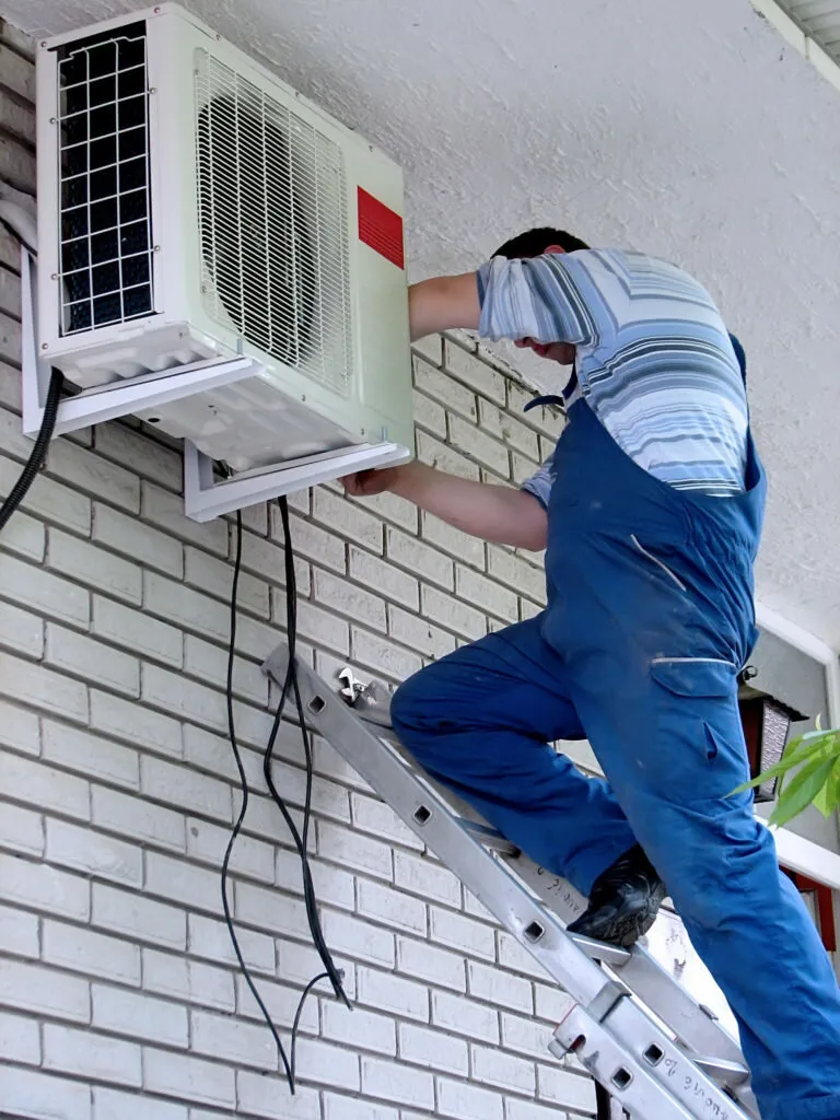 Technician repairing AC