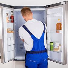 Technician repairing refrigerator