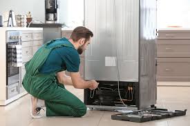 Technician repairing refrigerator