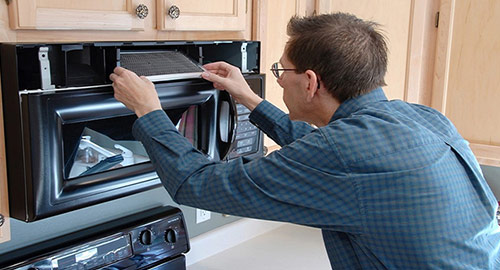 Technician repairing microwave