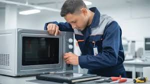 Technician repairing microwave oven
